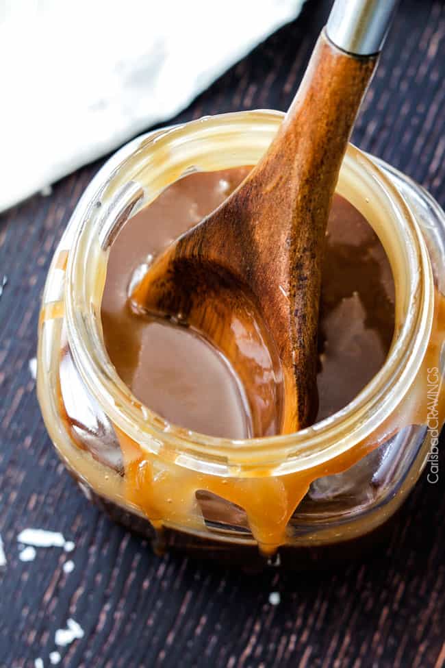 Top view of Coconut Caramel Sauce in a jar and serving spoon. 