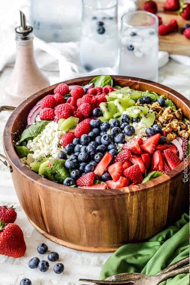 large serving bowl filled with feta spinach berry salad