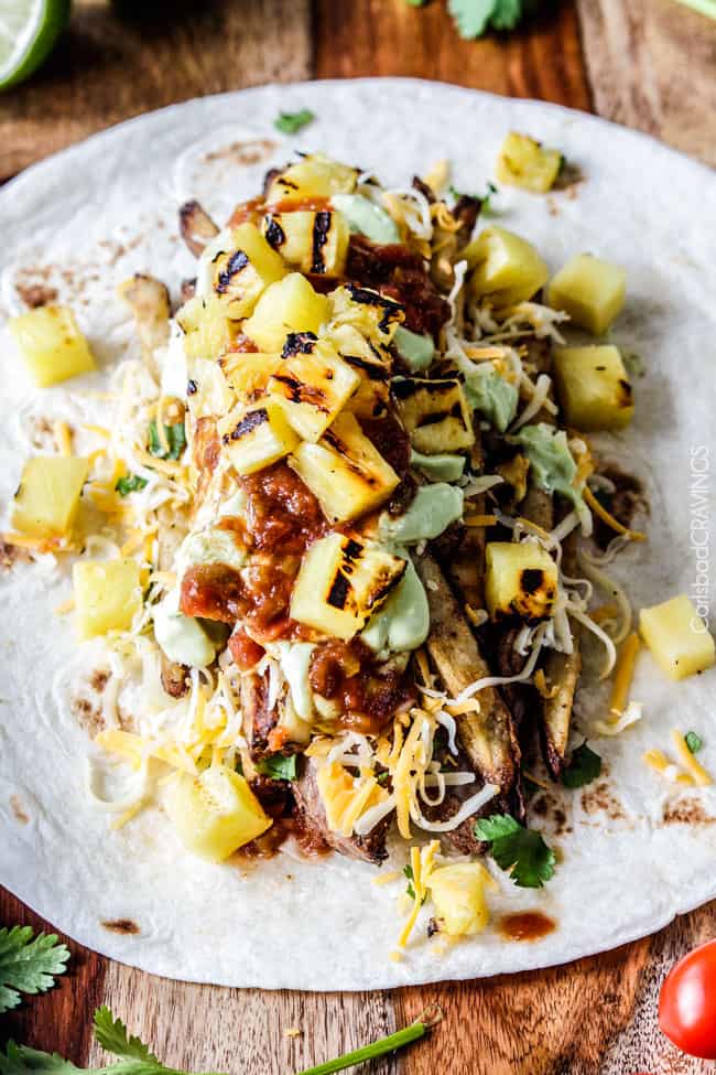 Outrageously delicious California Burritos stuffed with thinly sliced, tender marinated Carne Asada, cheese, salsa, avocado crema (pineapple optional) and the best part - Mexican French Fries!!! so easy, great for crowds at a fraction of the cost!