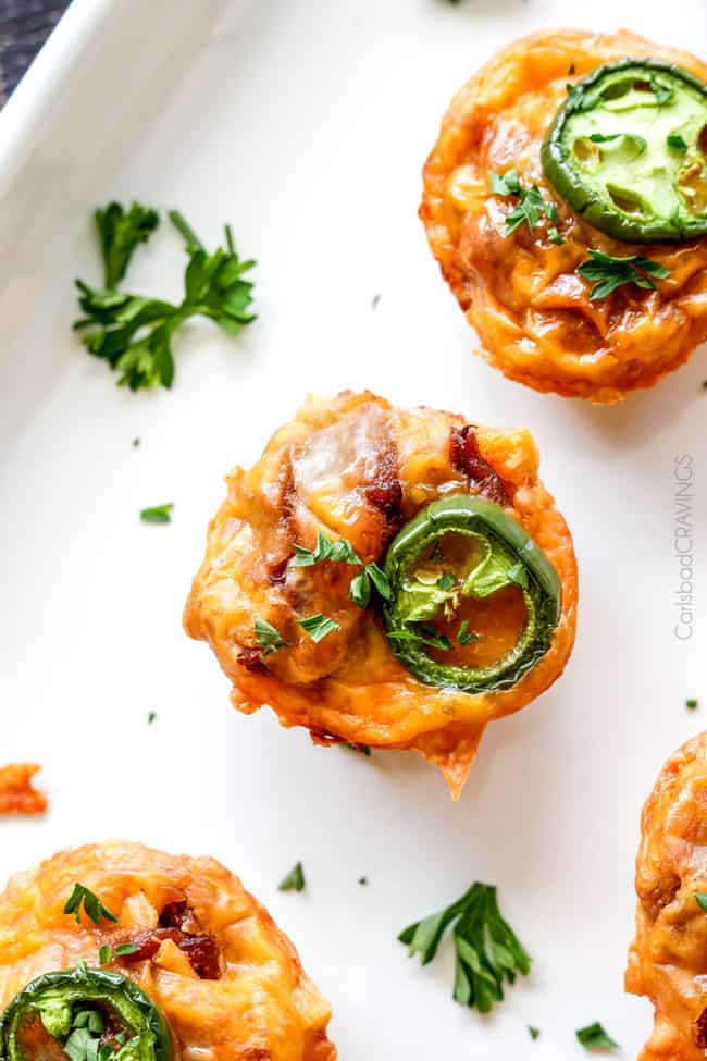 A top view of BBQ Brisket Bites with jalapeno and cheese and parsley. 