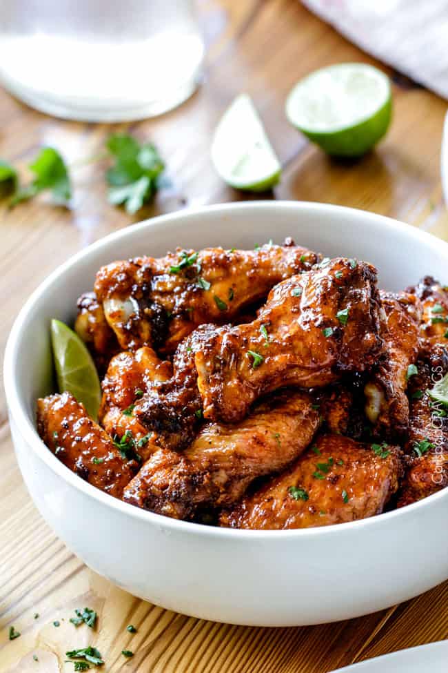 Baked Chipotle Honey Lime Hot Wings in a bowl with lime.