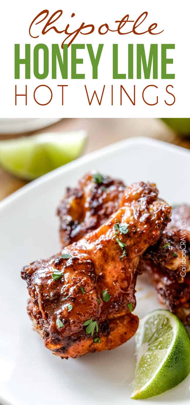 Baked Chipotle Honey Lime Hot Wings on a white plate with lime.