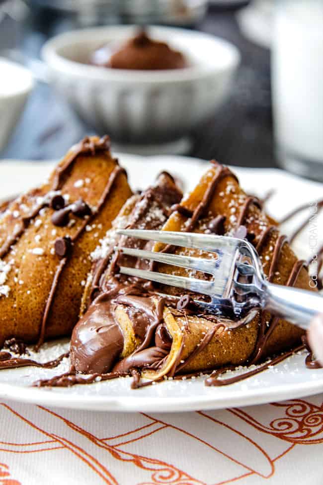Close up of Nutella Pumpkin Crepes being cut into by a fork. 