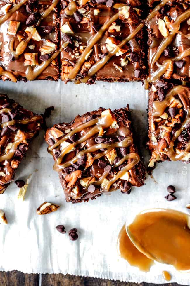 top view of salted caramel turtle brownies sliced into squares with salted caramel drizzled on top