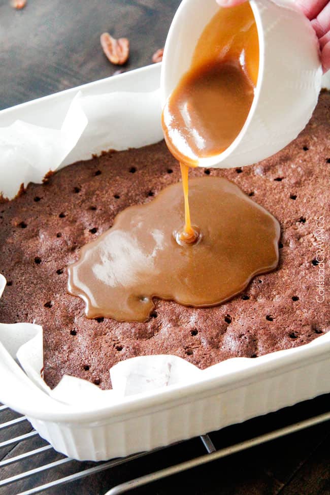 showing how to make Turtle Brownies by pouring caramel over the top of the chocolate brownies