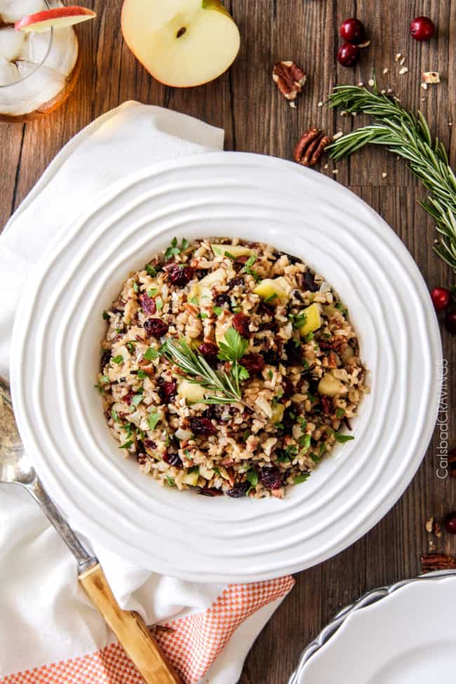 Easy one pot Cranberry Apple Pecan Rice Pilaf simmered in herb seasoned chicken broth and apple juice and riddled with sweet dried cranberries, apples and roasted pecans for an unbelievable savory sweet side dish perfect for the holidays. Everyone always asks for this recipe! 