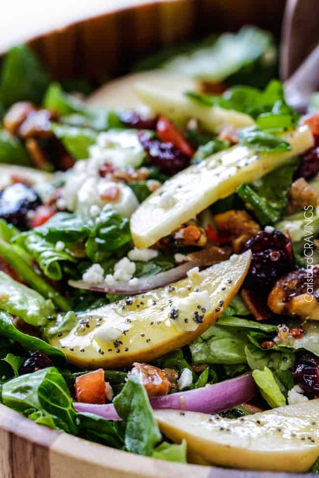 showing how to serve Apple Walnut Salad in a wood bowl with bacon