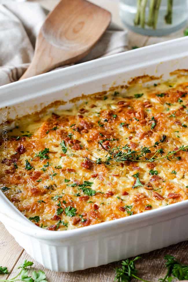 Looking for the BEST scalloped sweet potatoes ever EVER?! Fresh herbs simmered in cream poured over layers of potatoes, bacon and onions topped with Gruyere cheese. Perfect for Thanksgiving, company or every day!