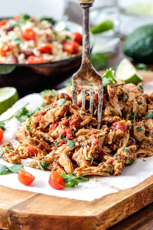 Easy Slow Cooker Shredded Mexican Chicken simmered with Mexican spices, salsa and green chilies for the BEST Mexican chicken perfect for tacos, burritos, tostadas, salads, etc. Couldn’t be any easier!