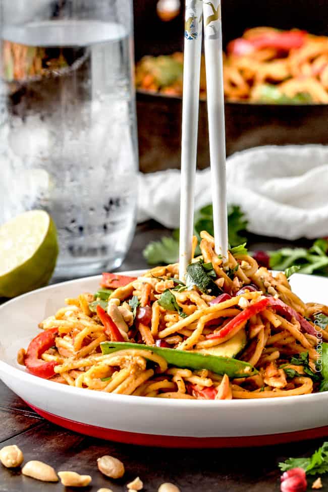 plate of thai pumpkin pasta. A pair of chopsticks is digging into the pasta. 