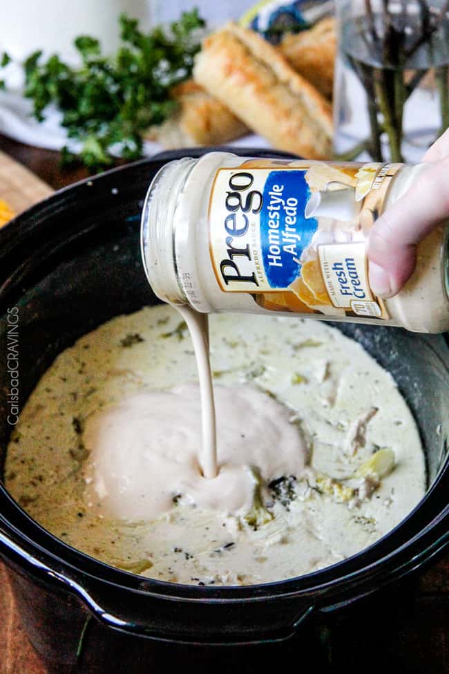 showing how to make Chicken and Wild Rice Soup by thickening it with cream in the crockpot 
