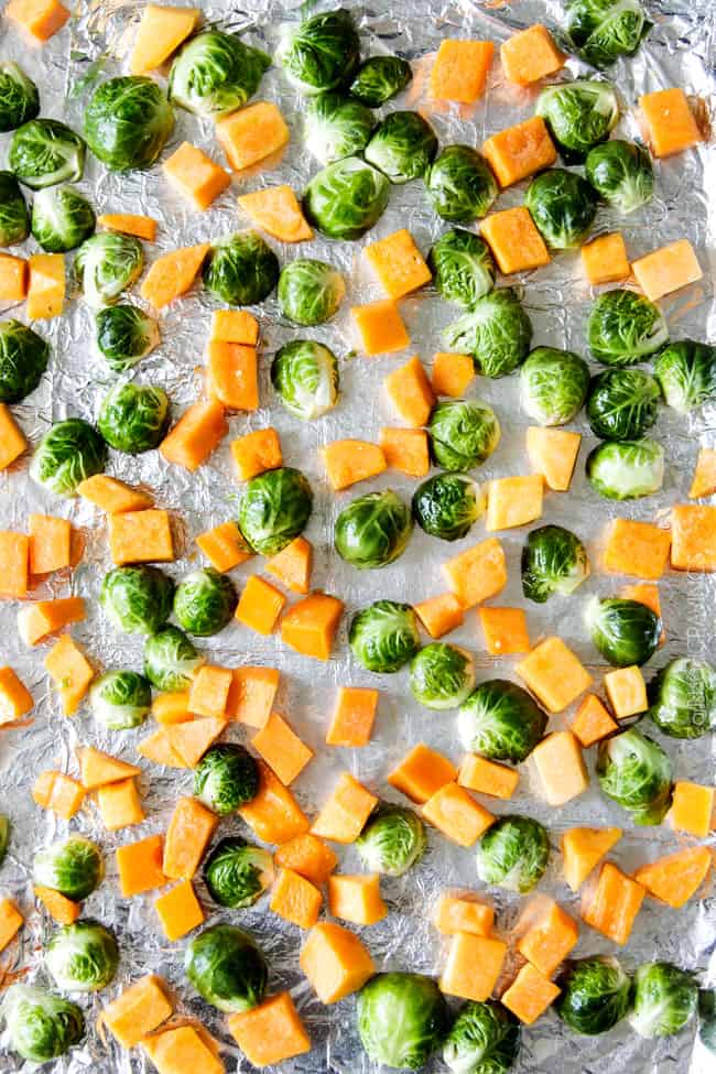 Showing how to make Roasted Brussels Sprouts and Butternut Squash by preparing to bake. 