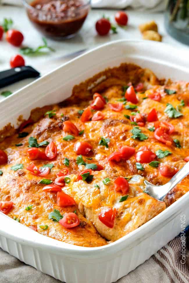 side view of breakfast enchiladas garnished with tomatoes