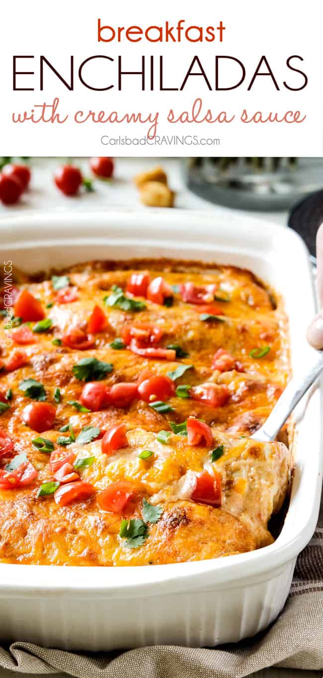 a pan of cheesy breakfast enchiladas with a spatula scooping up a serving