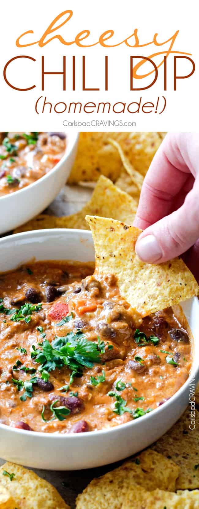 a chip dipping  into chili cheese dip with ground beef