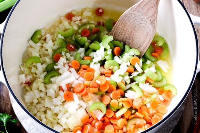 showing how to make Ham and Bean Soup by cooking onions, carrots, celery and carrots together with olive oil
