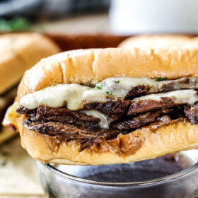 Crazy tender Slow Cooker French Dip Sandwiches seeping with spices are unbelievably delicious and make the easiest dinner or party food. You haven't had French Dip Sandwiches until you try these! absolutely the best!