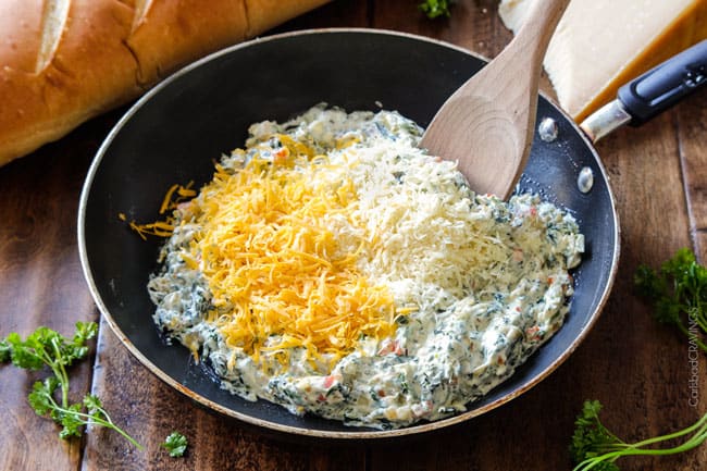 Showing how to make Spinach Dip Stuffed French Bread mixing cheeses in a pan.