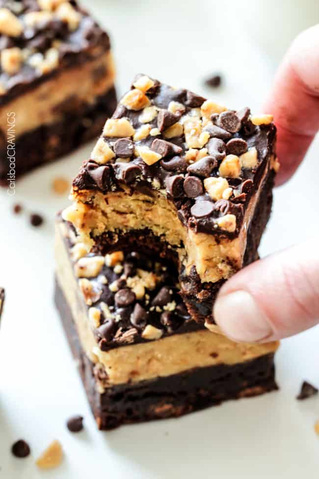 A single bite out of Toffee Chocolate Chip Cookie Dough Brownies