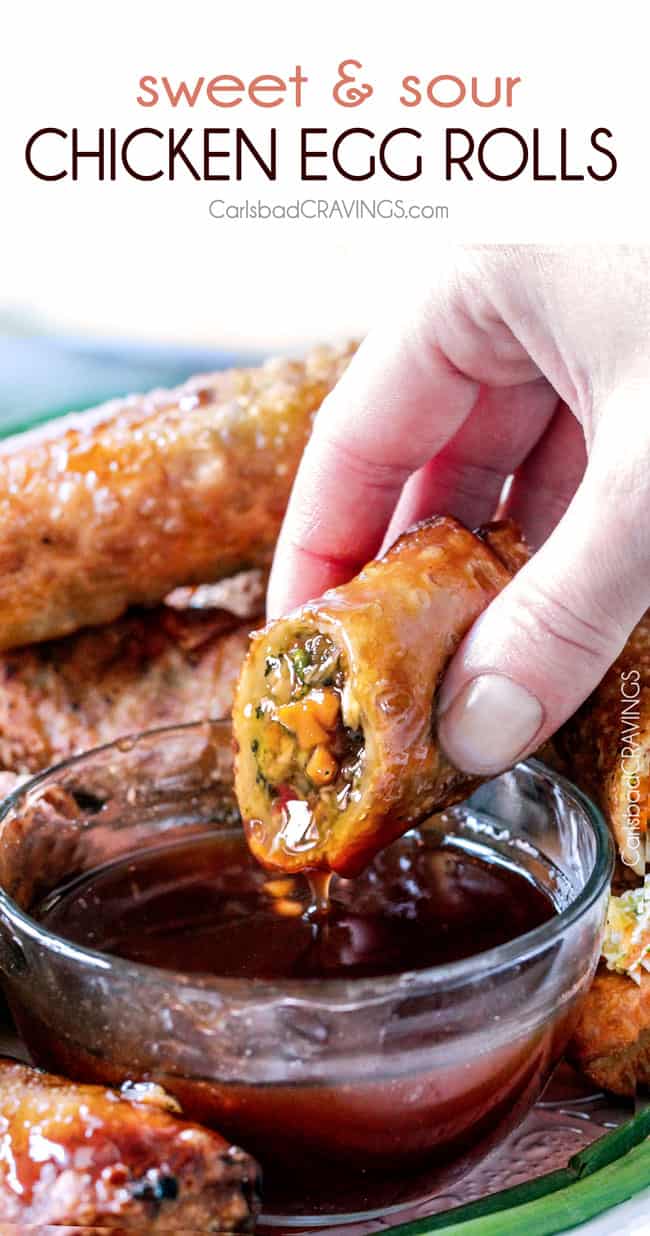 lifting up a chicken egg roll from being dipped in sweet and sour sauce