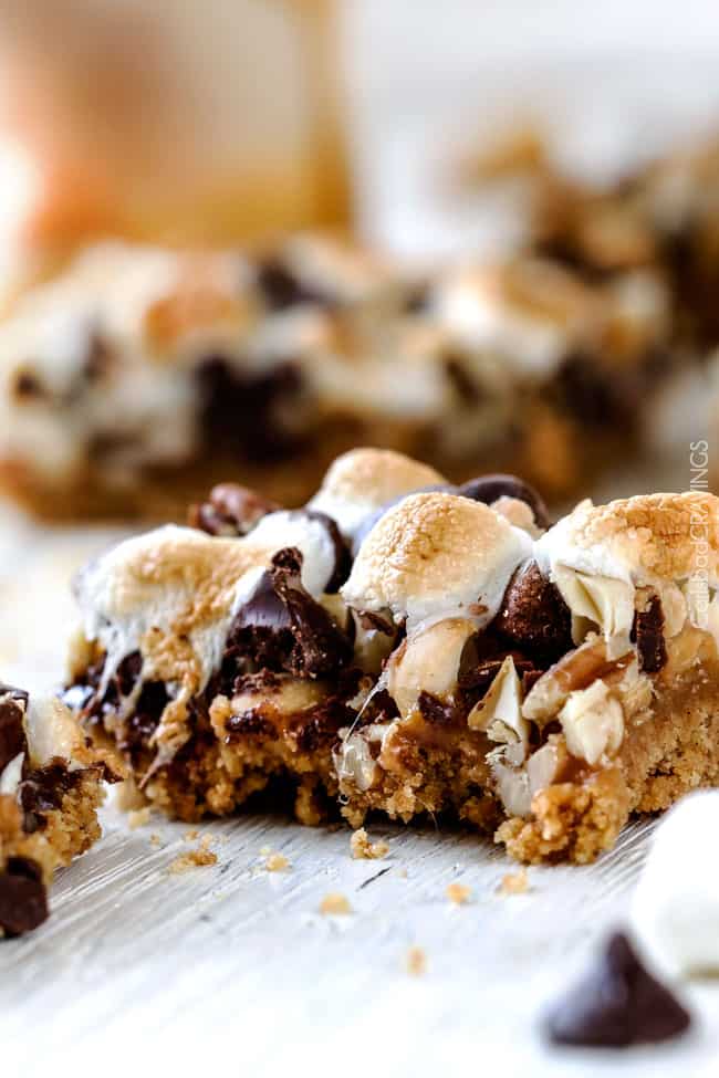 Close up of Caramel Nut S'mores Bars with a bite out of it. 