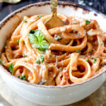 20 Minute Creamy, Lightened Up Sun-dried Tomato Fettuccine Alfredo smothered in a flavorful velvety sauce with a fraction of the calories! A great go-to dinner and totally customizable with chicken veggies, etc.