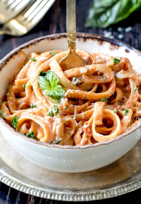 20 Minute Creamy, Lightened Up Sun-dried Tomato Fettuccine Alfredo smothered in a flavorful velvety sauce with a fraction of the calories! A great go-to dinner and totally customizable with chicken veggies, etc.