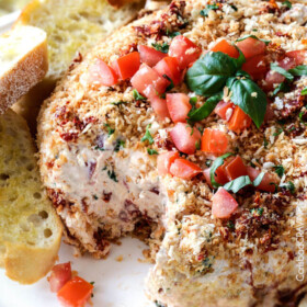 Super easy Bruschetta Cheese Ball takes just minutes to whip up and is always a total show stopper, make ahead appetizer! Loaded with fresh tomatoes, sun-dried tomatoes, fresh basil and garlic and herb cream cheese then rolled in crispy panko breadcrumbs all served with toasted baguette slices! So irresistibly delicious!