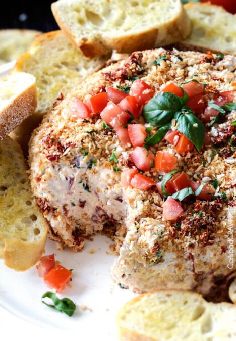 Super easy Bruschetta Cheese Ball takes just minutes to whip up and is always a total show stopper, make ahead appetizer! Loaded with fresh tomatoes, sun-dried tomatoes, fresh basil and garlic and herb cream cheese then rolled in crispy panko breadcrumbs all served with toasted baguette slices! So irresistibly delicious!