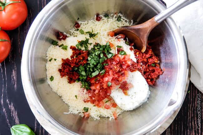Showing how to make Bruschetta Cheese Ball by mixing the ingredients.