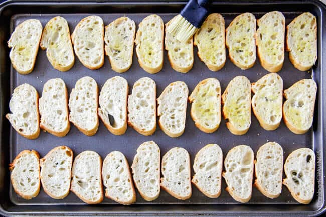 Showing how to make Bruschetta Cheese Ball by preparing toasted bread.