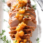 Easy, company pleasing Cajun Pork smothered in Tangy Pineapple Glaze is sweet and spicy and melt in your mouth tender! The layers of flavor or out of this world!