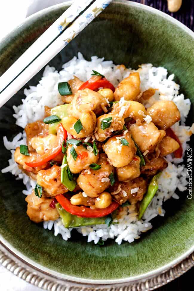 Honey Coconut Cashew Chicken Stir Fry over white rice and green onions.