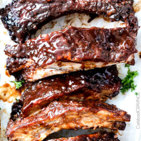 15 minute prep Fall-Off-the-Bone Slow Cooker Barbecue Ribs that everyone goes crazy for! They are slathered in the most incredible rub and barbecue sauce for amazing restaurant flavor. My husband says they are better and more tender than any restaurant!