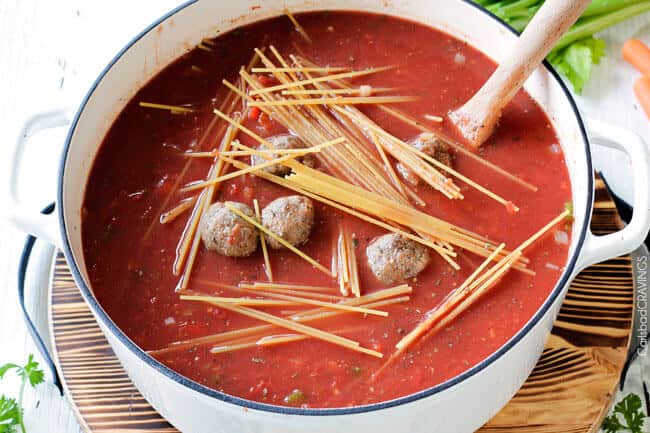 showing how to make Italian Meatball Soup by adding pasta to soup