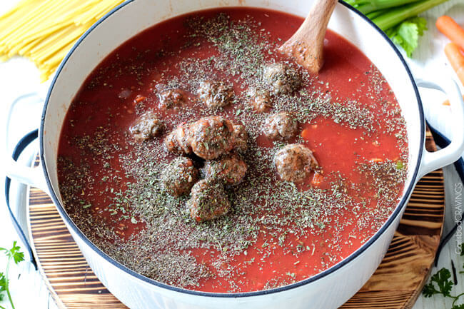 showing how to make Italian Meatball Soup by adding meatballs to the soup