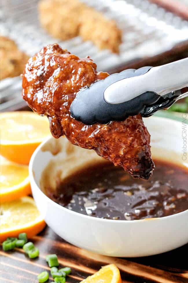 Tender, juicy Baked Orange Chicken Tenders are marinated and smothered in the most tantalizing sweet heat orange sauce you can't even imagine! You will crave this over your favorite Chinese orange takeout!