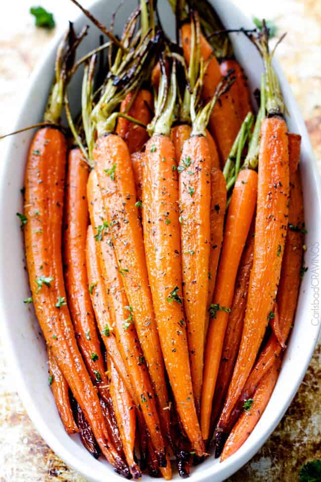 Tender, sweet and savory Secret Ingredient Honey Garlic Roasted Carrots are the most delicious carrots and easiest side dish EVER with only 10 minutes prep! I eat these like candy! #Thanksgiving #Easter #Christmas