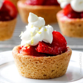 The best strawberry pie filling nestled in easy soft, buttery, sugar cookie crusts make the most adorable, crowd pleasing and delicious Mini Strawberry Pies! And they are make ahead for stress free entertaining!