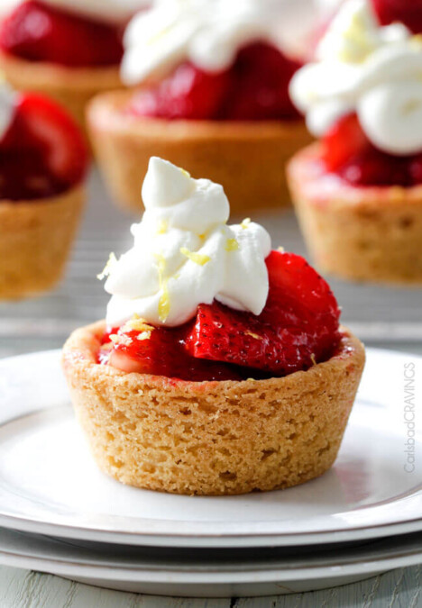 The best strawberry pie filling nestled in easy soft, buttery, sugar cookie crusts make the most adorable, crowd pleasing and delicious Mini Strawberry Pies! And they are make ahead for stress free entertaining!
