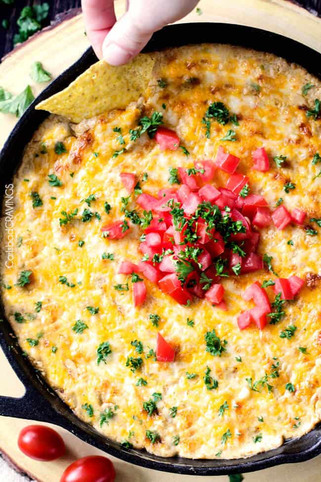 top view of best Mexican corn dip in a skillet with tomatoes and cilantro