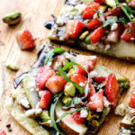this fresh, sweet and salty Strawberry Pear Pesto Flatbread with Balsamic Reduction Drizzle smothered in brie cheese and garnished with feta and pistachios is OUT OF THIS WORLD! and super easy! Amazing appetizer, brunch or lunch! #Easter #Christmas #holiday