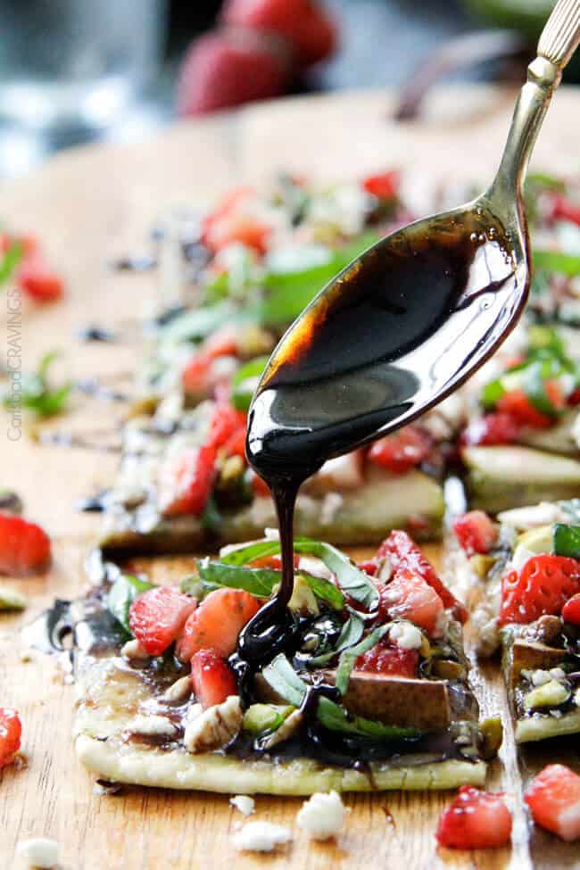 showing how to make Pear Gorgonzola Pizza by drizzling with balsamic reduction