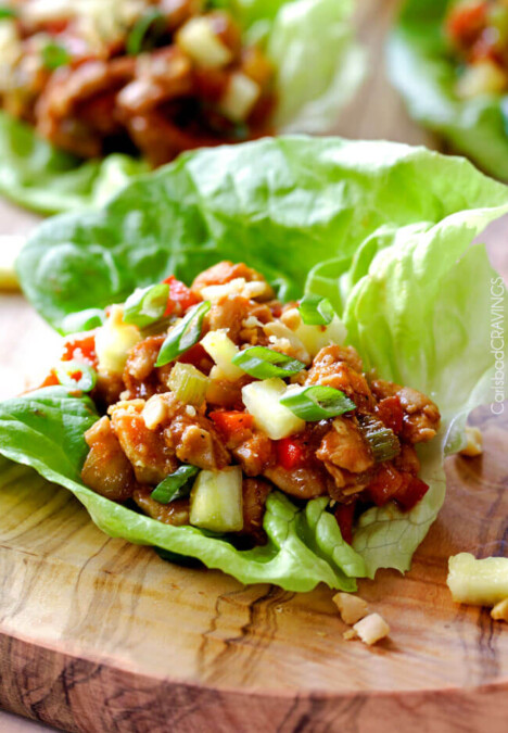 Quick and easy Asian Chicken Lettuce Wraps smothered in an unbelievable Pineapple Hoisin Peanut Sauce are 1000X better than takeout and on your table in under 30 minutes!