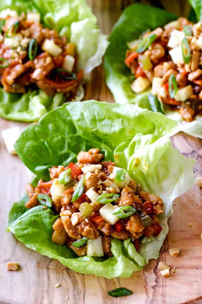 Quick and easy Asian Chicken Lettuce Wraps smothered in an unbelievable Pineapple Hoisin Peanut Sauce are 1000X better than takeout and on your table in under 30 minutes! 