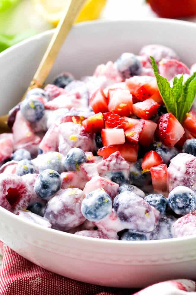 Fresh Berry Salad is one of the BEST fruit salads you will ever make! Smothered in sweet and tangy, incredibly creamy Honey Mascarpone that takes minutes to whip up and tastes incredible! Perfect for brunch, barbecues and all your pool side parties!