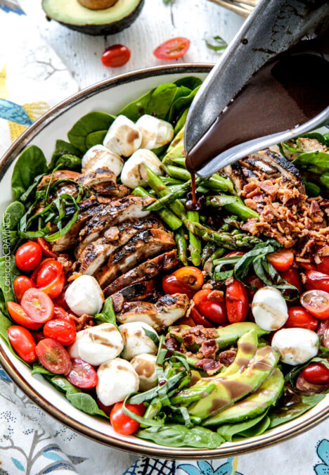Grilled Caprese Chicken Salad with the most incredible balsamic marinated chicken, fresh tomatoes, creamy mozzarella, grilled asparagus, creamy avocado and crispy bacon all drizzled with Creamy Balsamic Reduction Dressing. Out of this world! #summersalad #springsalad