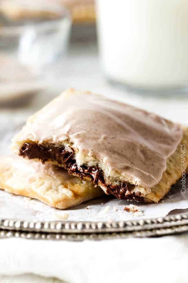 homemade pop tarts with chocolate filling laying on a white plate