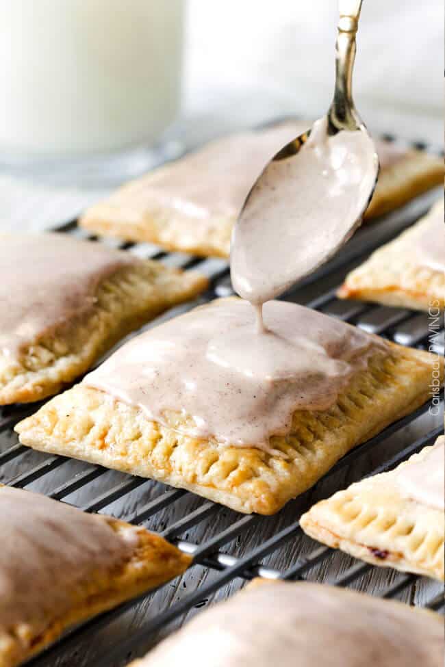 showing how to make homemade pop tarts by drizzling pop tarts with glaze