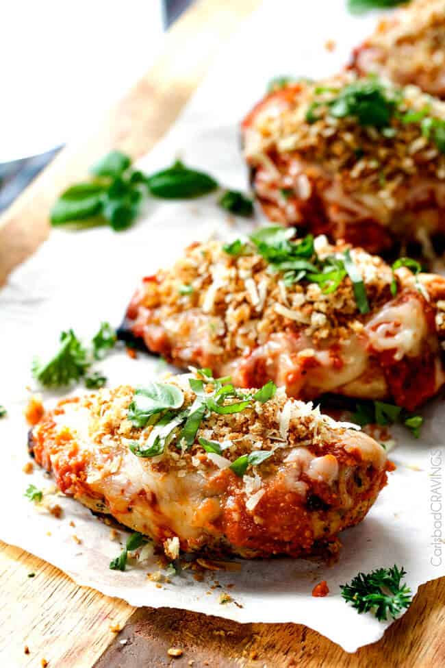 Skinny Chicken Parmesan on a white plate with basil on top.